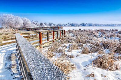 Snow covered field against sky