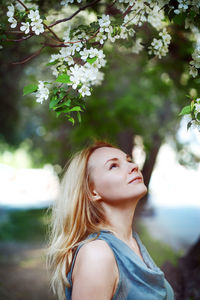 Beautiful woman looking at flowering plants