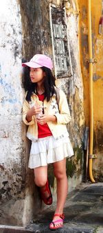 Full length of woman holding railing