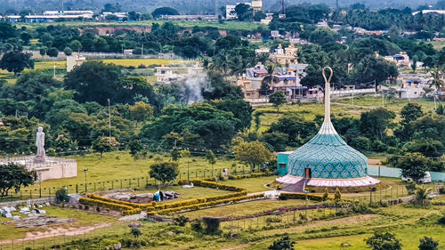High angle view of trees and buildings in city