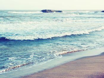 Waves rushing towards shore at beach