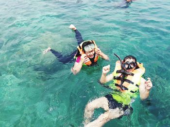 High angle view of people swimming in sea