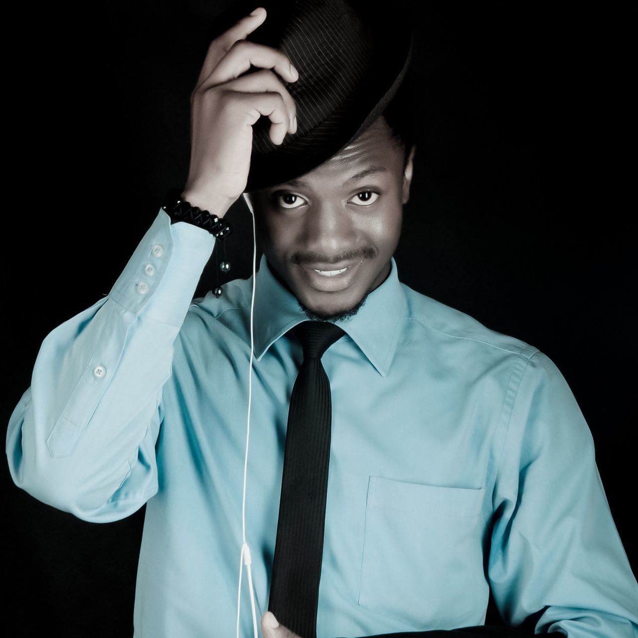 black background, lifestyles, studio shot, front view, indoors, person, holding, casual clothing, portrait, leisure activity, waist up, looking at camera, young adult, young men, headshot, men, close-up, beard