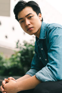 Portrait of young man sitting outdoors
