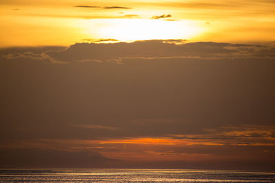 Scenic view of sea against romantic sky at sunset