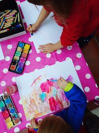 High angle view of child painting on table