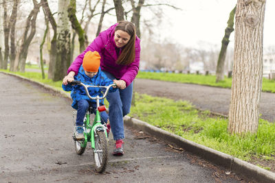 Side view of woman riding bicycle on road