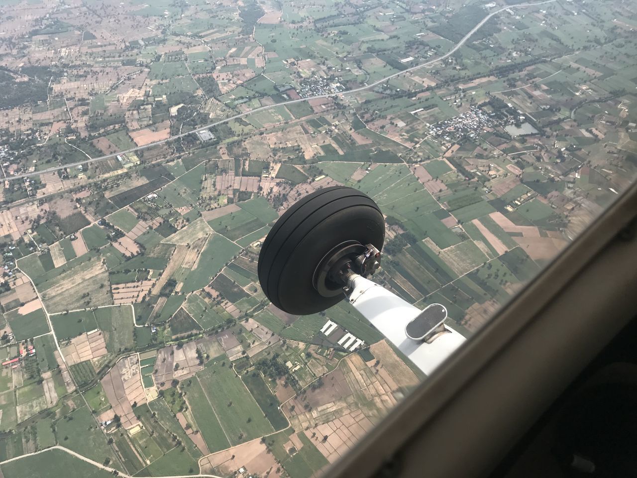 AERIAL VIEW OF CITYSCAPE SEEN THROUGH WINDOW