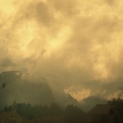 Scenic view of mountains against cloudy sky