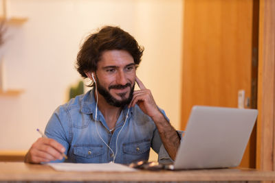 Young business man working with laptop. gray notebook for working. home office . 