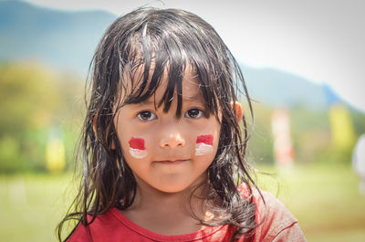 Close-up portrait of cute girl with paint on face