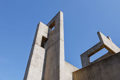 Low angle view of old building against clear blue sky