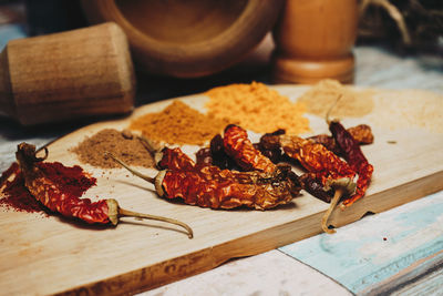 Spices and red chili peppers on table
