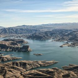 Scenic view of lake and mountains against sky