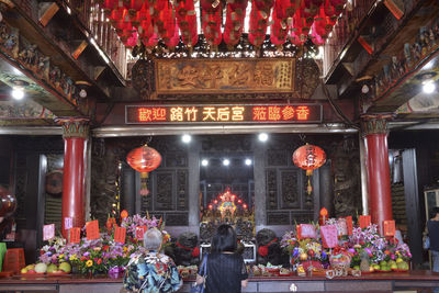 Group of people in illuminated building at temple