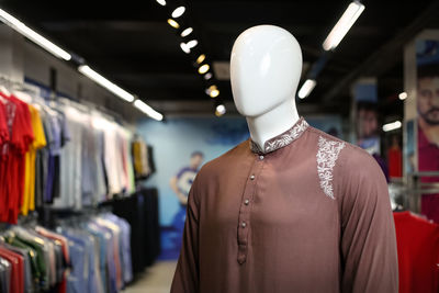 Close-up of brown kurta on mannequin in store