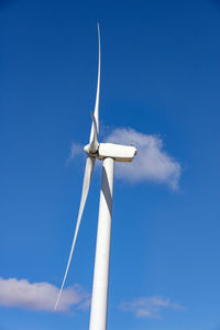 Wind turbine with blue sky and clouds