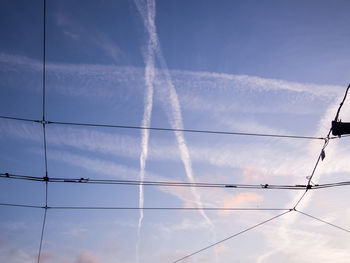 Low angle view of vapor trails against sky