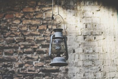 Old electric lamp against brick wall