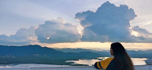 Portraits- rear view of woman looking at mountains against sky