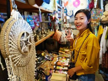 Portrait of woman standing at market stall