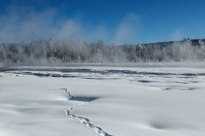 Frozen landscape against sky