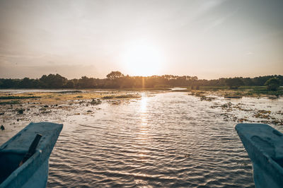 Scenic view of lake against sky during sunset