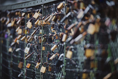 Close-up of padlocks hanging on railing