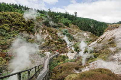 Footbridge over mountain in foggy weather