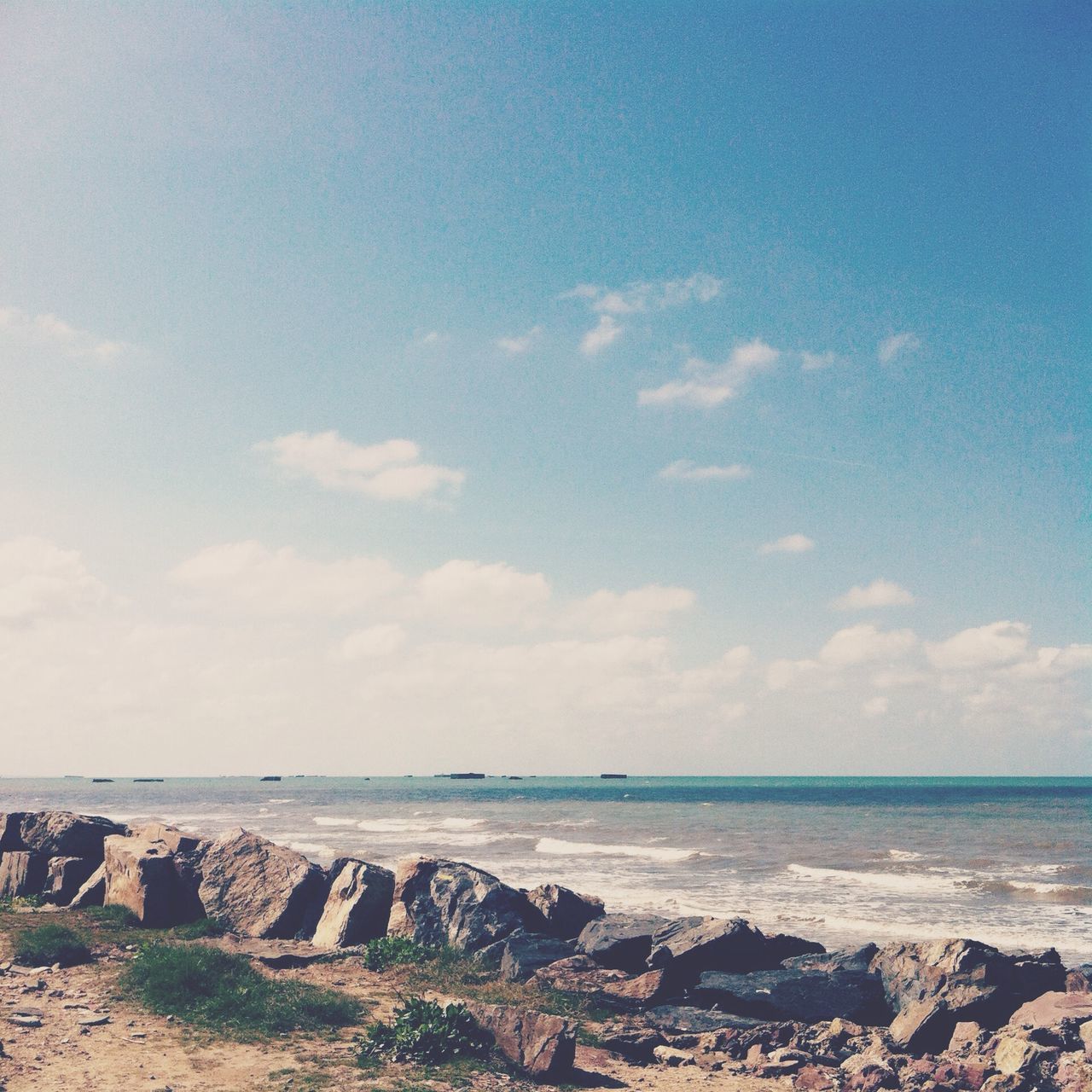 sea, horizon over water, water, beach, sky, tranquil scene, tranquility, scenics, shore, beauty in nature, nature, blue, sand, cloud - sky, idyllic, cloud, rock - object, coastline, day, remote