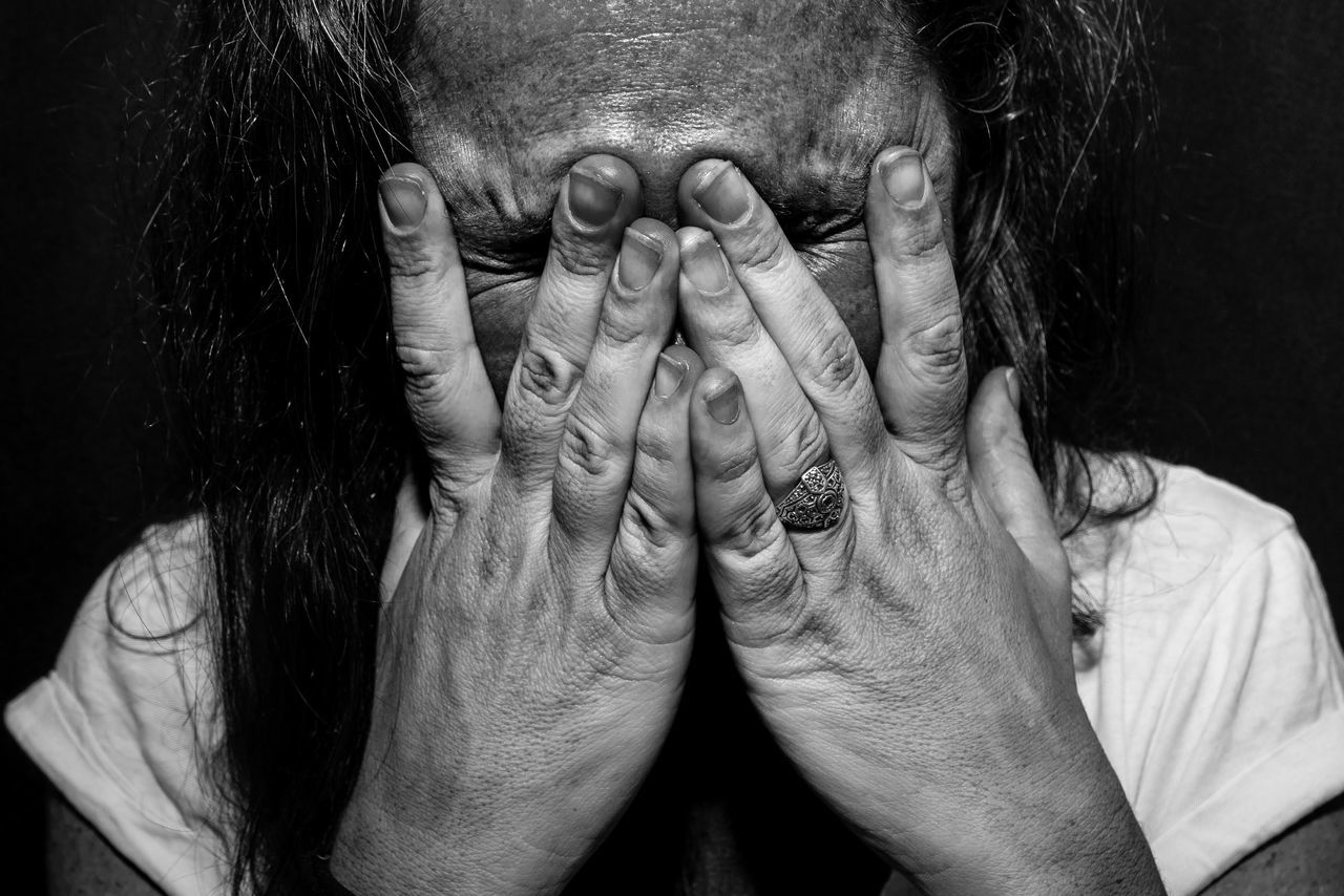 hand, human hand, one person, front view, human body part, real people, obscured face, covering, portrait, body part, indoors, adult, headshot, close-up, unrecognizable person, emotion, hands covering eyes, lifestyles, women, head in hands, human face, mature men, hairstyle, depression - sadness, finger