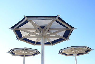 Three beach umbrellas against the blue sky