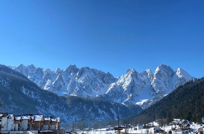 Snowcapped mountains against clear blue sky