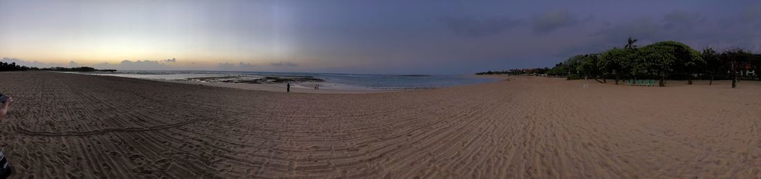 Panoramic view of beach against sky during sunset