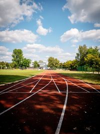 Diminishing perspective of sports track against sky