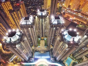 Low angle view of illuminated buildings in city at night