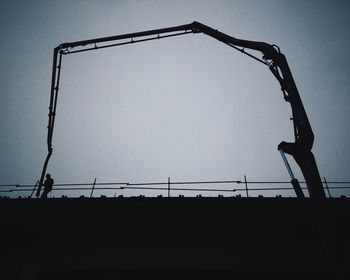 Low angle view of power lines against clear sky