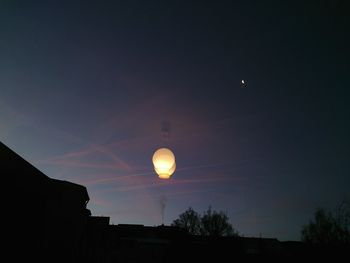 Low angle view of silhouette moon against sky at night