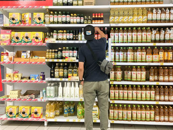 Rear view of man standing at store