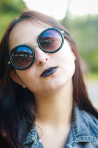 Close-up portrait of young woman wearing sunglasses