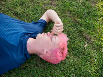 High angle view of man lying on grassy field