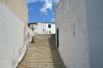 Staircase amidst white buildings against sky