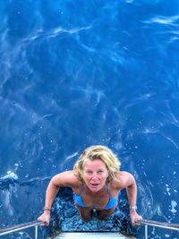 Portrait of a smiling young woman in swimming pool