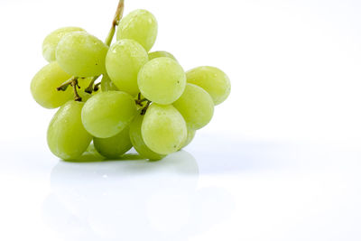 Close-up of grapes over white background