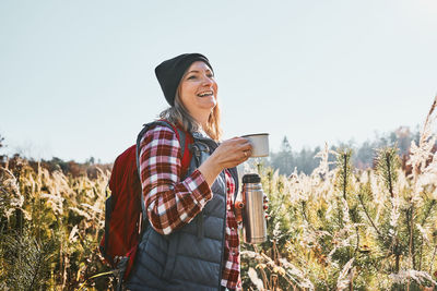 Smiling woman relaxing and enjoying the coffee during vacation trip. leisure time close to nature