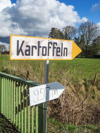 Low angle view of road sign against sky