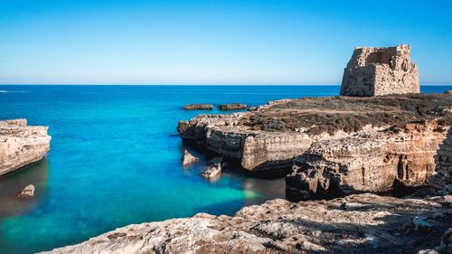 Scenic view of sea against clear blue sky