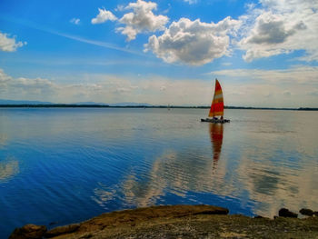 Sailboat in sea against sky