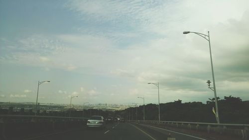 View of road against cloudy sky