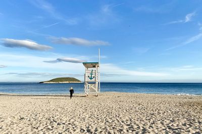 Lifeguard hut on beach against sky